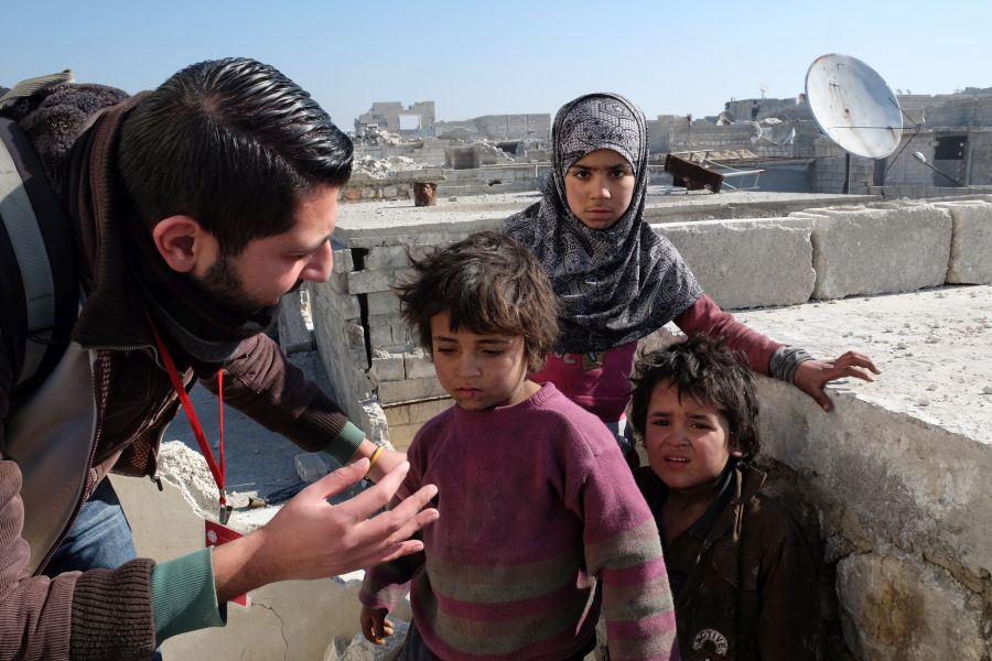 Caritas Mitarbeiter mit syrischen Kindern